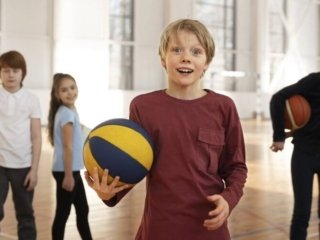 Kids stand with great enthusiasm and style, eagerly preparing to start playing volleyball showing best kids volleyball shoes