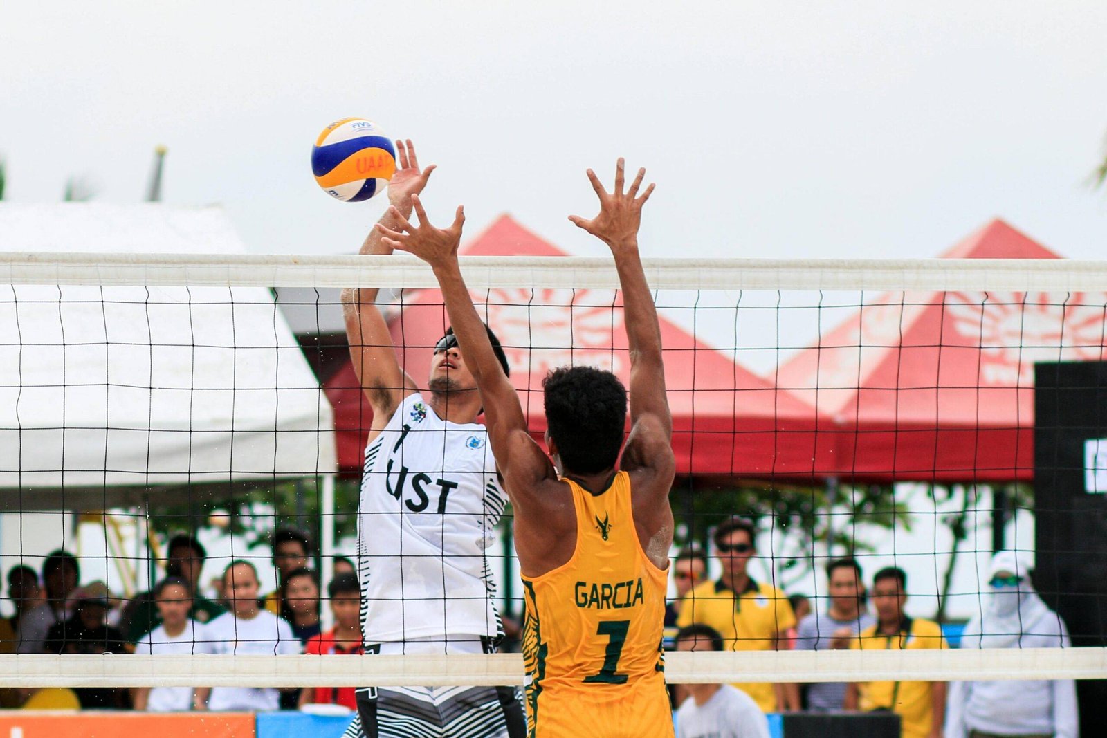 Best Outdoor volleyball match featuring teams in yellow and white uniforms.