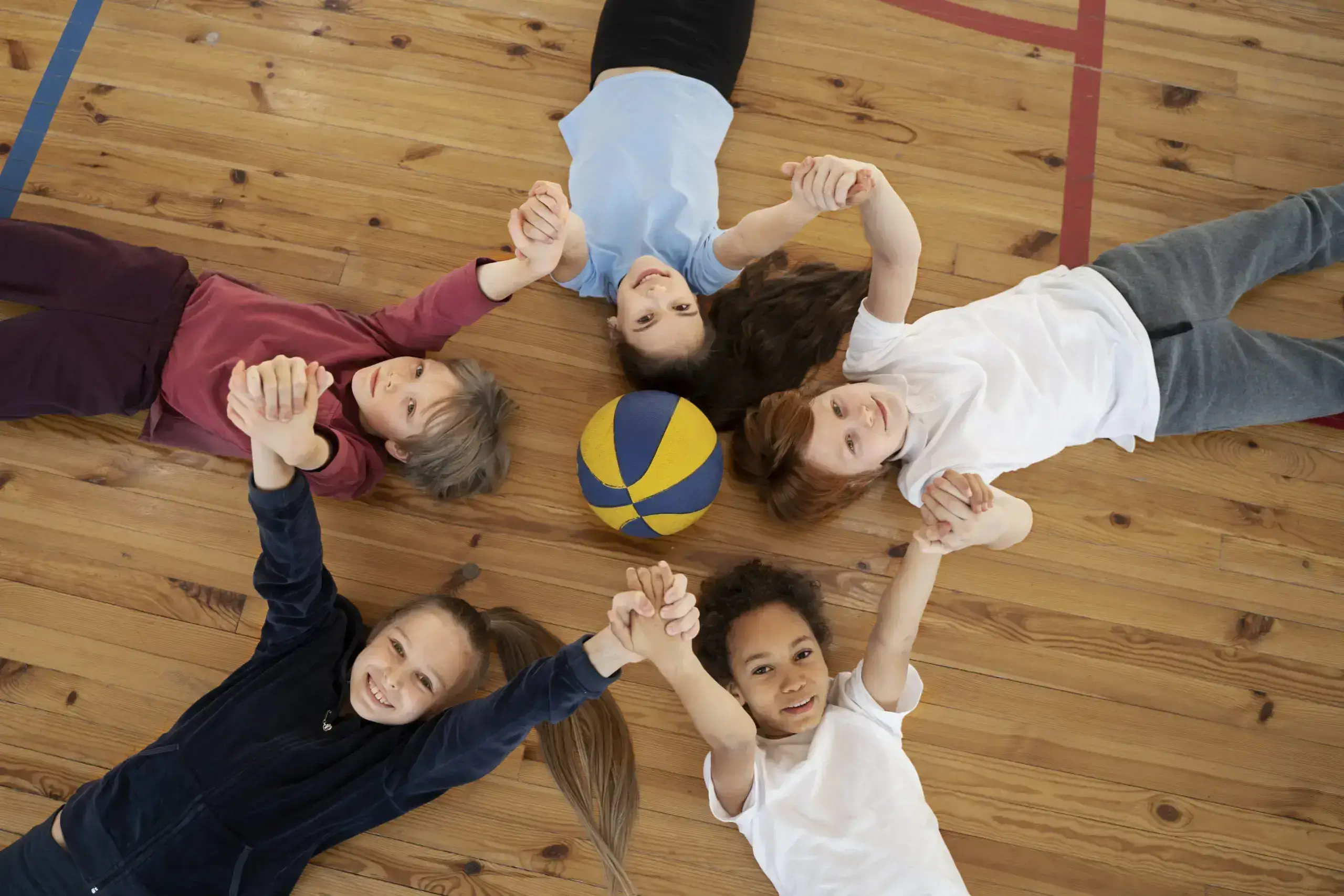 a group of boys on gym floor with unity showing best kids volleyball shoes