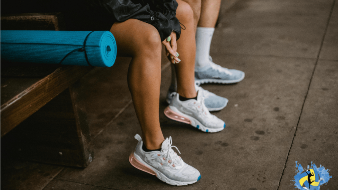 boys and girls sitting on a table wearing white sports shoes for volleyball