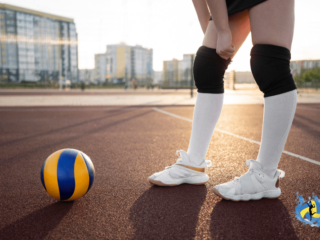 a girl in outdoor volleyball court with a volleyball in front of her wearing technology volleyball shoes