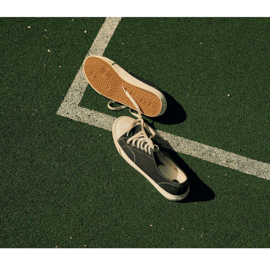 Pair of old sneakers in the grass court 